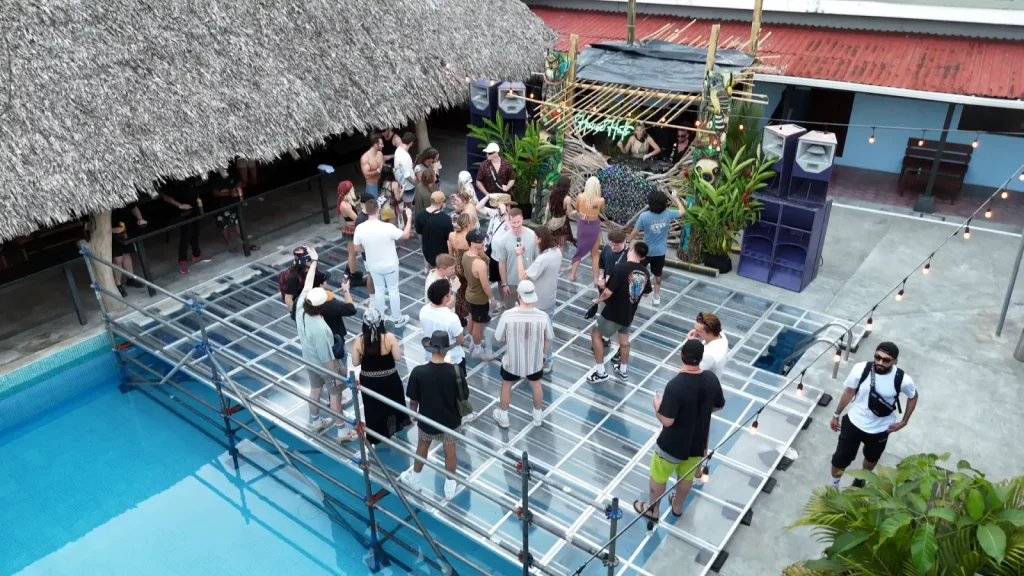 Drone photo of a party group in the pool area at Republik Pool & Disco in Jacó Beach, Costa Rica.