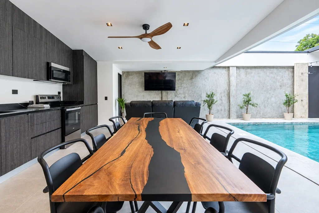 Kitchen and dining area overlooking the pool at Palma Roots Villa, Jaco Beach, Costa Rica