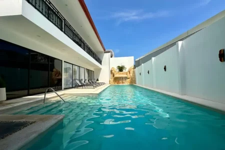 Side view of the back patio and pool at Ocean Breeze Villa in Jaco Beach, Costa Rica